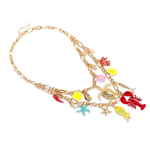 Layered gold necklace featuring colorful lobster, turtle, and coral ocean-themed charms