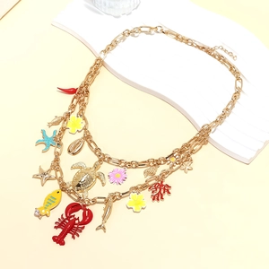 Detailed layered gold necklace featuring colorful lobster, turtle, and sea star charms