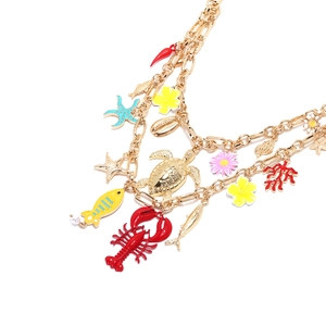 Multi-layer gold necklace featuring lobster, sea turtle, and coral enamel charms