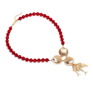 Beaded necklace with red beads and golden ocean charms like shells and fish