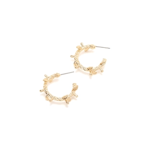 Detailed view of gold C-shaped earrings with natural branch texture and thorn design
