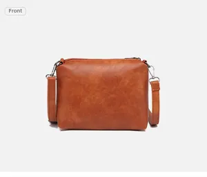 Vista frontale di una borsa a tracolla marrone caramello con cerniera e spalline in pelle