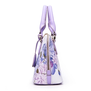 Floral print shell handbag with purple textured leather trim and gold zipper accents