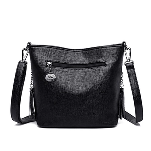 Elegant black lychee leather bucket bag for women with decorative side tassels and metal logo