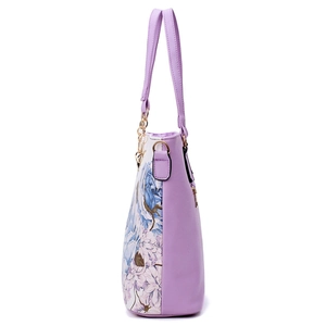 Chic lavender purple tote bag with floral print side panels and golden chain handles