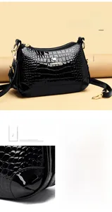 Détail du cuir verni noir gaufré crocodile avec coins renforcés et logo doré brillant