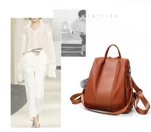 Brown lychee grain faux leather backpack with anti-theft back zipper and pompom charm