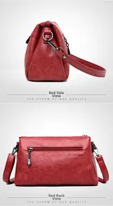 Detail view of the red soft leather shoulder bag with zipper pocket and metal hardware