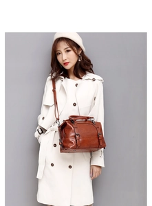 Model showcasing a vintage brown oil wax leather tote bag with adjustable shoulder straps
