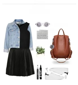 Chic outfit with light blue denim jacket, pleated black dress, and brown leather backpack