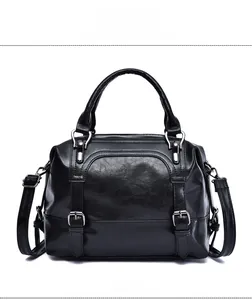 Front view of black wax leather pillow bag with metal buckle and adjustable strap