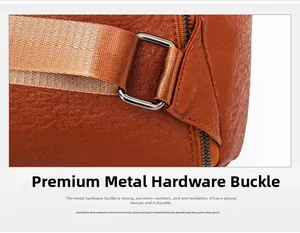 Detail of durable brown leather bag with silver metal ring and nylon shoulder strap