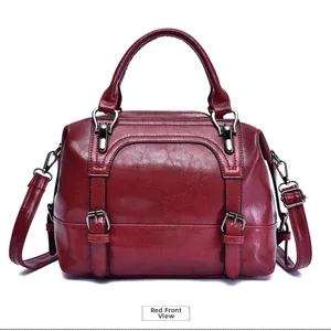 Front view of burgundy oil wax leather tote bag with metallic buckle detail