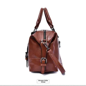 Close-up of brown oil wax leather handbag showing textured surface and side zipper detail