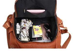 Interior view showing the large capacity and zipper pocket of this brown leather backpack