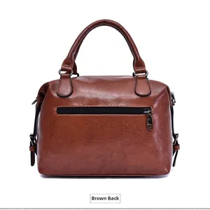 Rear view of brown oil wax leather pillow bag showing textured back zipper pocket