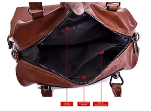 Detail view of leather handbag interior with zipper pocket and slip pocket compartments