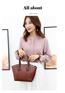 Brown crocodile embossed tote bag styled with a purple shirt and white polka dot skirt