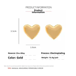 Detail view of large gold heart earrings with 3.5cm x 3.9cm dimensions and 16.4g weight