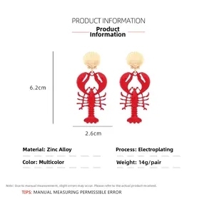 Detail of red lobster drop earrings with gold shell studs showing exact dimensions and weight