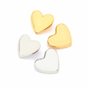 Polished gold and silver heart-shaped stud earrings set on a clean white background