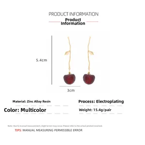 Detail view of resin cherry drop earrings showing dimensions of 5.4cm height and 3cm width