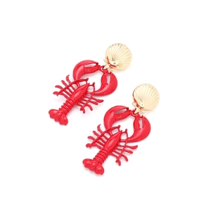 Close-up of red enamel lobster earrings with gold shell studs on a white background