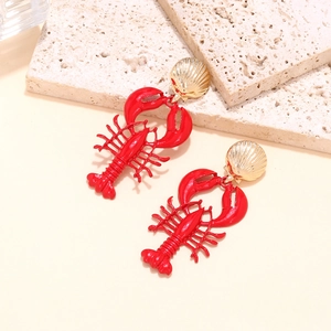 Chic red lobster pendant earrings with golden shell studs on a stone background