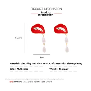 Detailed view of red enamel lip earrings with teardrop pearls and size measurements