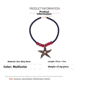 Detail of beaded starfish necklace with navy blue beads and red resin blocks