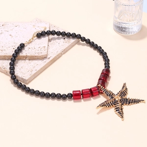 Bohemian beaded starfish necklace with black beads and gold-tone maritime pendant