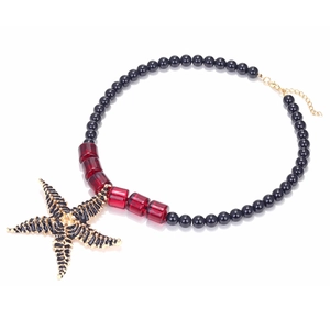 Bohemian ocean style handmade beaded necklace with golden starfish pendant on white background