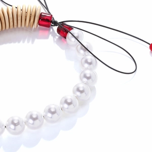 Close-up of handmade beaded necklace with wooden discs and white faux pearls