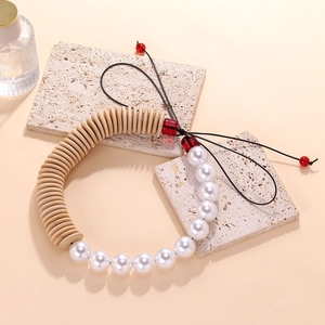 Handmade beaded necklace with wooden discs and white pearls on travertine stones
