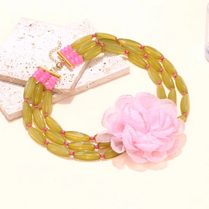Three-layer bohemian beaded necklace with green resin beads and a large pink fabric flower