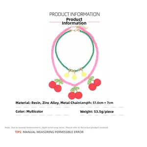 Detailed view of layered cherry and flower necklace with size and material specifications