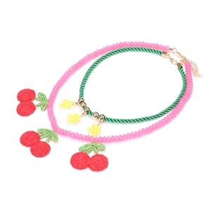 Pink beaded and green woven cherry necklace set with floral pendant on white background