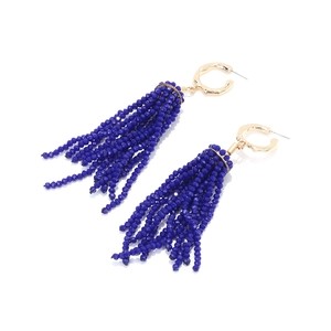 Detailed view of long dark blue crystal bead tassels on gold-tone textured hoops