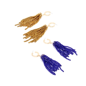 Detail of long crystal tassel earrings in bronze gold and royal blue beaded fringe