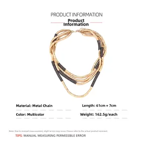 Close-up of bohemian multilayer necklace with golden and black metallic beaded tubes