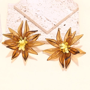 Exaggerated 3D amber resin flower beaded earrings on textured travertine stone