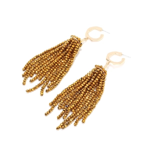 Close-up of golden long tassel earrings featuring irregular C-shaped geometric metal design