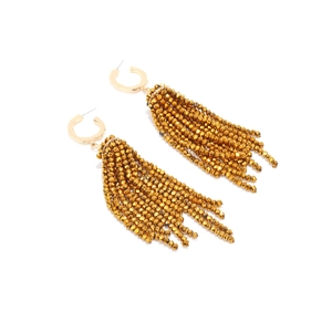 Detailed close-up of long gold fringe earrings with crystal beads on a white background