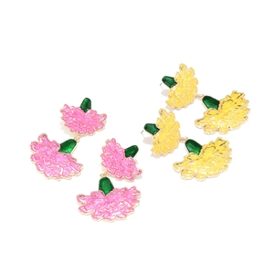 Detail of colorful enamel carnation flower earrings in pink and yellow with gold finish