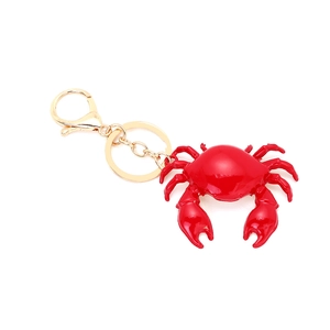 Detailed view of creative red crab keychain with golden clasp and polished finish