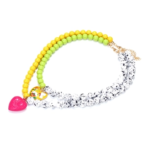 Colorful beaded necklace with pink embossed heart and yellow floral enamel pendant