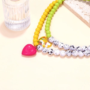 Detail of colorful beaded necklace with floral enamel heart charms and art resin beads