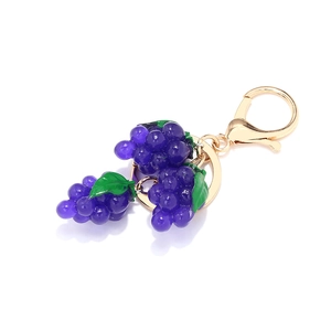 Porte-clés raisin violet artisanal avec feuilles vertes et fermoir doré sur fond blanc