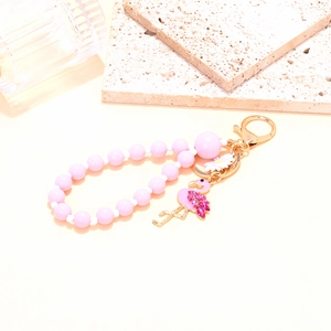 Porte-clés flamant rose perlé avec strass brillants et pendentif marguerite blanche