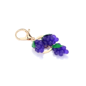 Porte-clés grappe de raisin violet avec feuilles vertes et fermoir doré sur fond blanc